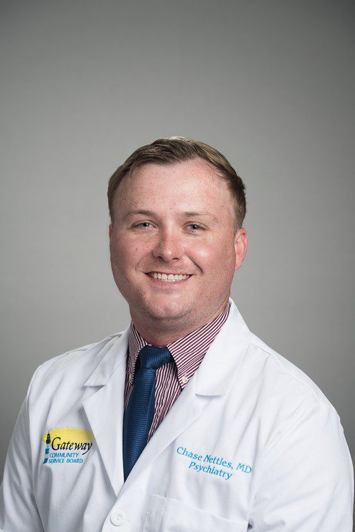 Portrait of a smiling male doctor in white coat and tie.